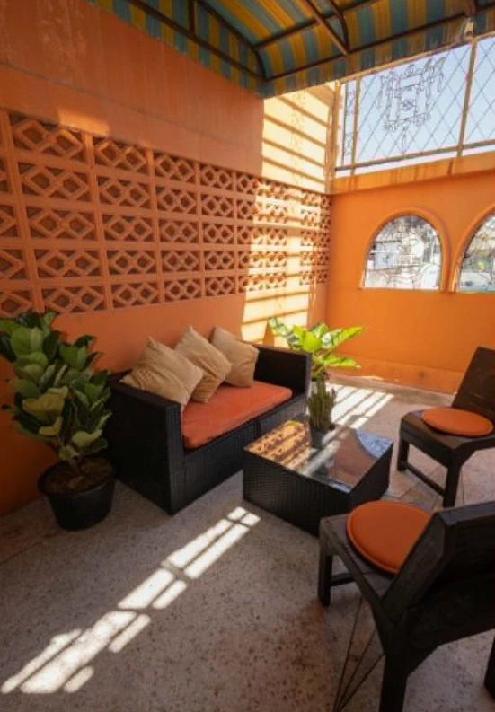 Balcony lounge and seating area at Born Free Hostel Bangkok