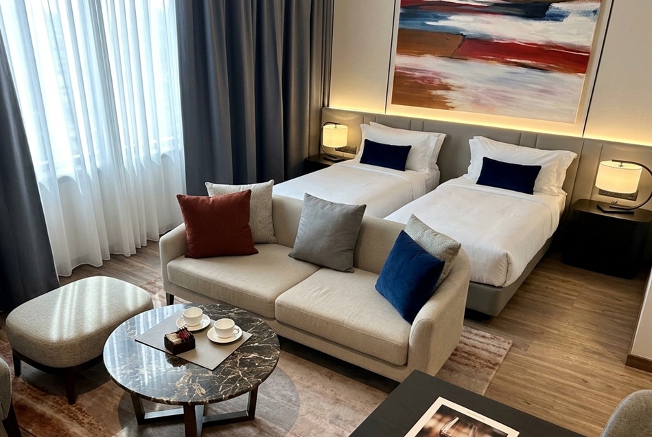 Twin guest room with sofa at Ascott Embassy Sathorn Bangkok