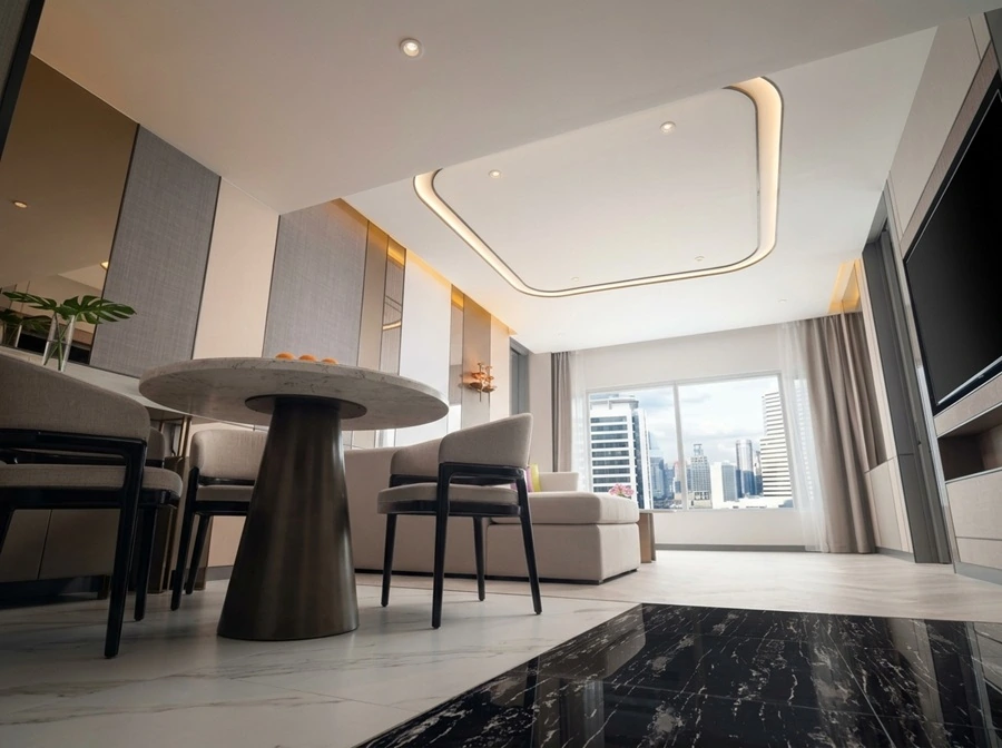 Large suite living and dining area with Bangkok city view at Pathumwan Princess Hotel
