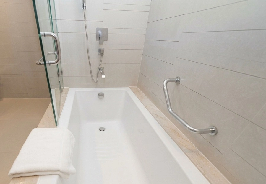 Bathroom with bathtub and separate shower at Pathumwan Princess Hotel